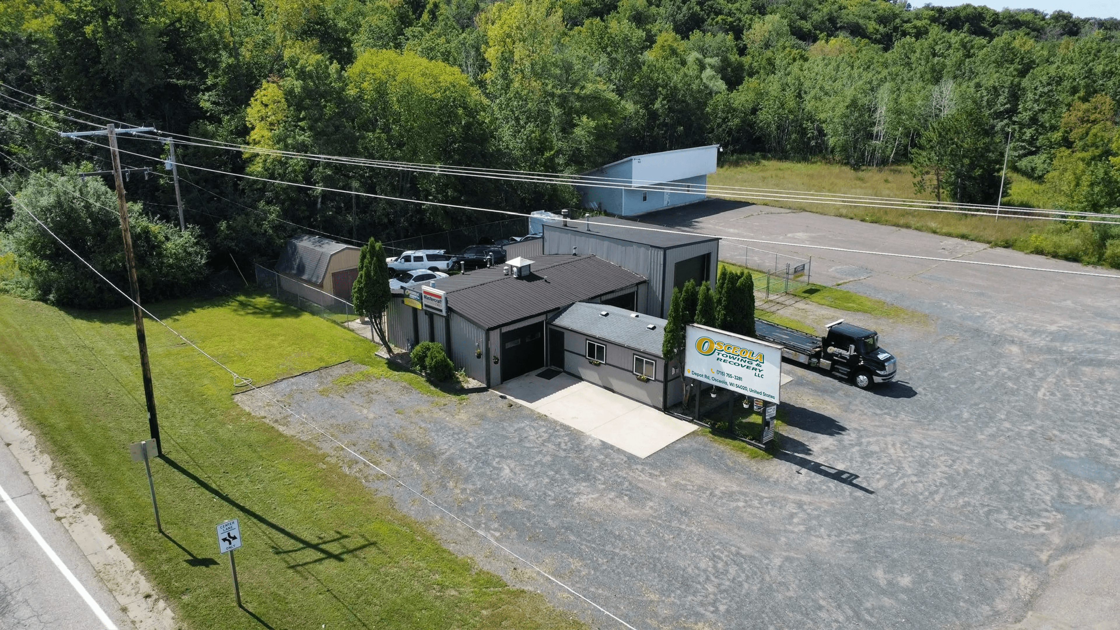 Osceola Towing facility with service vehicles ready for dispatch